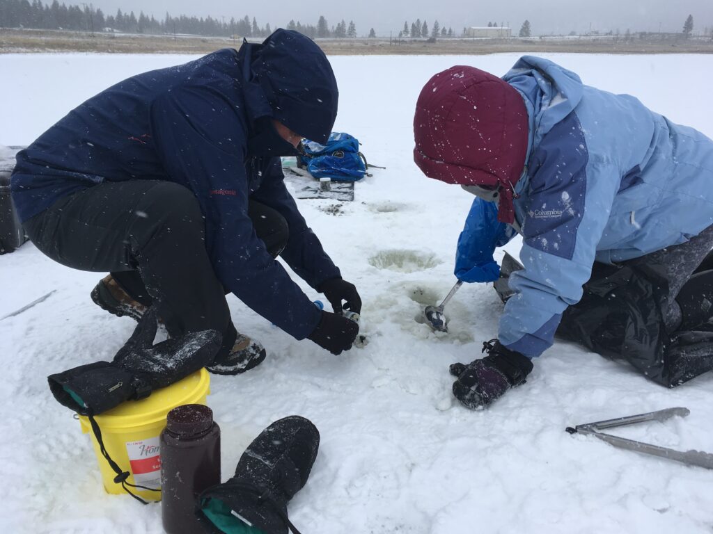 Alex Pontefract and Hannah Dion-Kirschner (Northwestern University) extracting sediment and salt samples through a borehole at Salt Lake. The brine temperatures can be as cold as -4C.